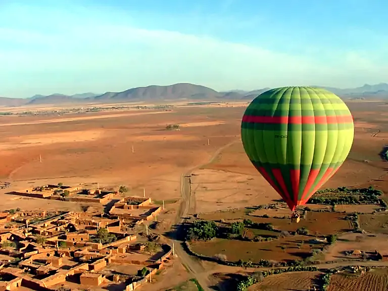Hot air balloons inflating at dawn near Marrakech